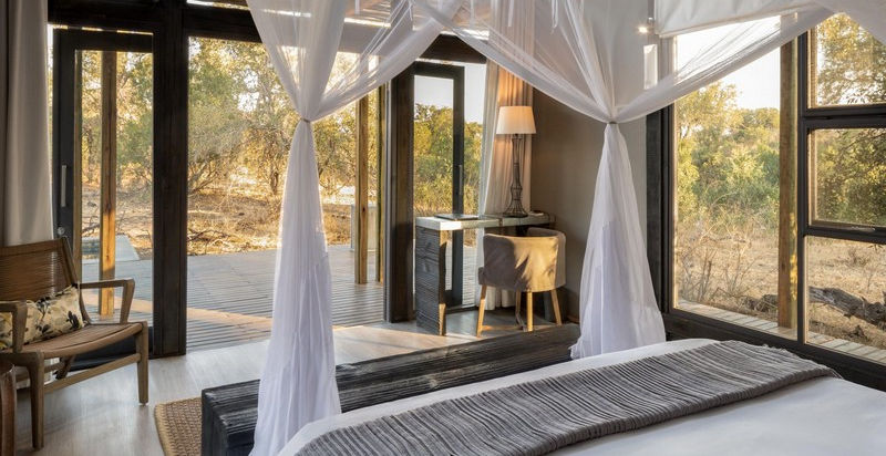 Simbavati River Lodge in Guest Suite with King bed and windows looking over the bush at The Timbavati, Greater Kruger in South Africa with Safari Ambitions