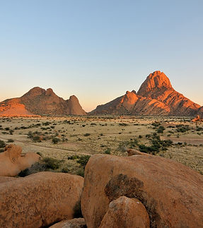 Safari Camps and Lodges in Namibia: Desert Luxury and Wilderness Solitude

Namibia is a country of contrasts — where red dunes meet endless skies, where wildlife roams beneath ancient rock formations, and where silence carries the stories of a land shaped by time. In this stark yet stunning landscape, safari camps and lodges offer travelers a front-row seat to one of Africa’s most surreal and hauntingly beautiful wilderness experiences.

Far from the crowds of more traditional safari destinations, Namibia's lodges and camps invite solitude, reflection, and a deeper connection with nature. Whether you’re tracking desert-adapted elephants, stargazing under crystal-clear skies, or waking to the sound of jackals in the distance, staying in a Namibian safari lodge is about more than just comfort — it’s about immersion.

The Namibian Safari Experience

Unlike the densely populated savannahs of East Africa, Namibia offers vast, open landscapes where animals are spread across wide distances and where the journey often feels just as rewarding as the destination. The safari experience here is slower, more introspective, and often framed by a sense of isolation that heightens every moment of wildlife or landscape encounter.

From the dry riverbeds of Damaraland to the grassy plains of Etosha, Namibia’s ecosystems are diverse — and so too are the camps and lodges that inhabit them.

Types of Safari Camps and Lodges in Namibia
1. Desert Camps

Namibia’s iconic desert regions — including the towering dunes of the Namib and the windswept gravel plains of the Skeleton Coast — are home to minimalist, design-forward camps that blend seamlessly into the environment. These camps are often constructed with eco-conscious materials and offer open-air sleeping platforms, outdoor showers, and sweeping desert views. While wildlife is less concentrated here, sightings of oryx, springbok, and even lions against dune backdrops are unforgettable.

2. Luxury Lodges

Scattered across Namibia’s protected areas and private reserves are upscale lodges that offer sophisticated comfort in remote settings. These lodges typically feature spacious suites or villas with large windows or decks overlooking waterholes, salt pans, or river valleys. Many include swimming pools, wine cellars, and gourmet dining, all set against dramatic natural scenery.

3. Tented Safari Camps

For those seeking a more classic safari ambiance, Namibia offers tented camps that strike a balance between rugged adventure and comfort. These are not basic campsites, but carefully curated spaces with canvas walls, real beds, and en-suite bathrooms. Some are mobile or seasonal, while others are permanent fixtures in the landscape, offering guided game drives, nature walks, and sundowner experiences.

4. Eco-Lodges and Community Camps

Namibia is a leader in community-based conservation, and many of its lodges are owned or operated in partnership with local communities. These camps prioritize sustainability, cultural heritage, and responsible tourism. Visitors often have opportunities to learn about local traditions, participate in conservation programs, or support nearby villages through their stay.

Regional Diversity of Lodging Experiences
Etosha National Park

In and around this vast salt pan ecosystem, lodges range from rustic bush camps to luxurious retreats. Accommodations are often positioned near waterholes, allowing for spectacular wildlife viewing directly from camp. Game drives here offer chances to spot large herds of elephants, rhinos, lions, and antelope against the backdrop of cracked white earth and acacia woodlands.

Damaraland and Kaokoland

These rugged, mountainous regions in the northwest are home to desert-adapted wildlife and ancient rock engravings. Lodges here often emphasize remoteness and cultural integration, with low-impact designs and an emphasis on tracking rare species like black rhinos and elephants. The scenery is breathtaking — stark, silent, and endlessly photogenic.

The Namib Desert

In this region of red dunes and petrified trees, safari camps are often built to take advantage of sunrise and sunset views over the shifting sands. Some offer guided walks to explore desert-adapted flora and fauna, while others provide scenic drives or balloon safaris. Despite the extreme environment, these camps offer exceptional comfort and a deep sense of place.

The Skeleton Coast

Wild and remote, this stretch of Atlantic coastline is defined by fog, shipwrecks, and wind-sculpted dunes. Lodges here are few and far between, making the experience intensely personal and private. Guests can explore dry riverbeds, track elusive wildlife, and discover one of the planet’s last true wildernesses.

The Zambezi Region (Caprivi Strip)

In this narrow strip of fertile, river-fed land in the northeast, lodges are often located along the banks of rivers like the Zambezi and Kwando. This region contrasts sharply with the rest of Namibia, offering lush wetlands, tropical birdlife, and boat-based safaris reminiscent of those in neighboring countries like Botswana.

What to Expect During Your Stay

Intimate Settings: Most camps and lodges are small, often with fewer than 10 rooms or tents, ensuring a quiet and personalized experience.

Scenic Design: Many are architecturally striking, designed to complement the surrounding landscape and maximize views.

Guided Activities: Daily excursions typically include game drives, bush walks, scenic hikes, and cultural visits, led by experienced local guides.

Night Skies: With minimal light pollution, Namibia offers some of the best stargazing on Earth — many camps even provide telescopes or open-air “star beds.”

Sustainability: A strong focus on conservation, water efficiency, and solar power means that your stay often supports the health of the ecosystem you’re exploring.

Choosing the Right Safari Accommodation

When selecting a camp or lodge in Namibia, consider the following:

Location: Each region offers different wildlife and scenery. Your ideal destination may depend on what you're hoping to see and experience.

Style: Do you prefer rustic charm, modern luxury, or a balance of both?

Access: Some remote lodges require charter flights or long drives. Logistics can affect your itinerary and costs.

Activities: Some lodges focus more on wildlife, others on landscapes, culture, or adventure. Choose based on your personal interests.

Final Thoughts

Namibia’s safari camps and lodges are more than places to rest — they are portals into the soul of one of Africa’s most extraordinary countries. Whether set among towering dunes, overlooking ancient dry riverbeds, or hidden deep in rocky hills, these accommodations offer a rare blend of tranquility, luxury, and authenticity.

In Namibia, the experience of where you stay is inseparable from the journey itself. Each campfire under the stars, each panoramic sunrise, each whisper of the desert wind — these are the moments that define a Namibian safari. And they’re waiting just beyond your doorstep.