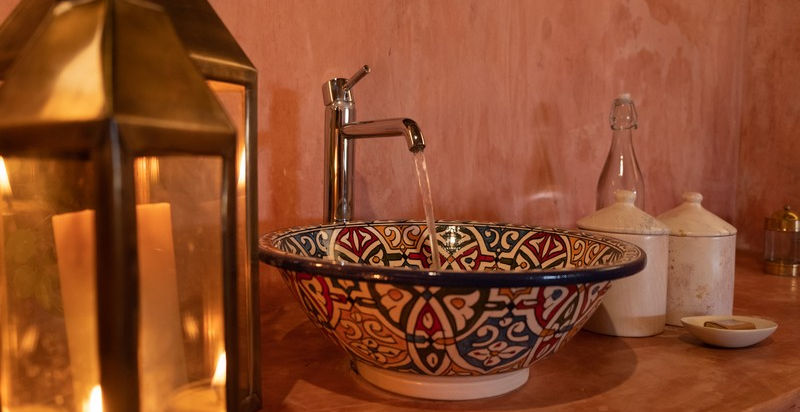 Blue and white washbasin with lantern at Saruni Rhino Camp in Samburu, Kenya