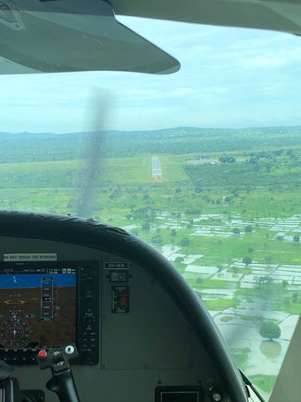 Flying Safaris in Africa - Looking out of a plane landing at a remote airstrip in The Okavango Delta, Botswana