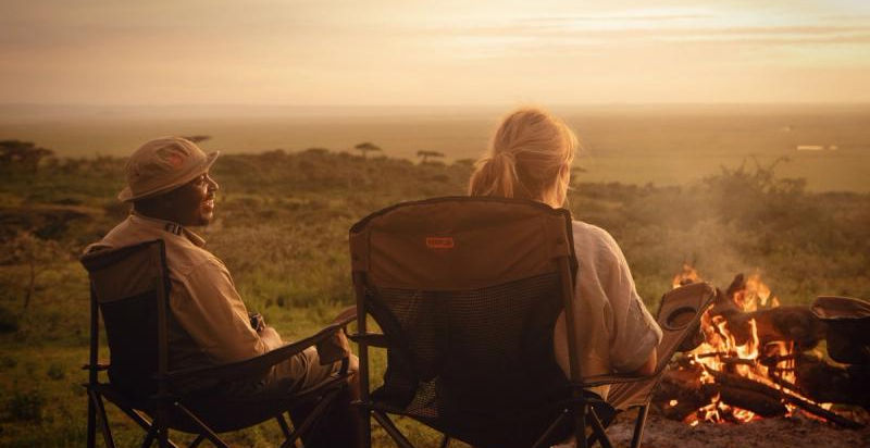 Couple at a mobile safari tent at Expeditionary Walking Camp in Ruaha, Serengeti and Ugalla wit Safari Ambitions