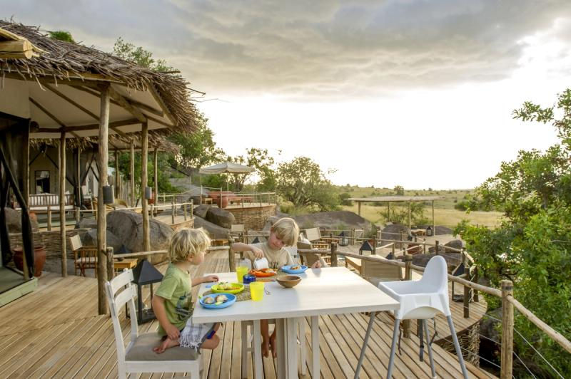 Deck overlooking The Serengeti with children playing at Mkombe's House in Lamai, Serengeti in Tanzania with Safari Ambitions