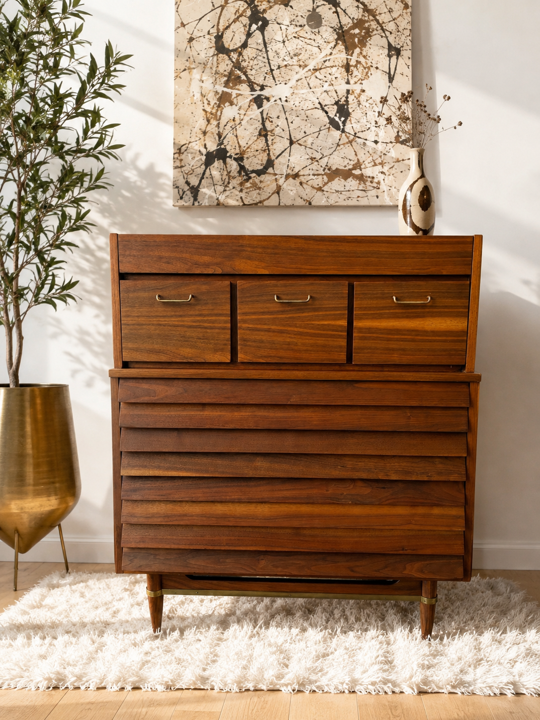 Restored American of Martinsville Dania walnut chest with solid brass pulls and brass base detail