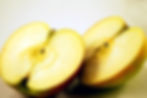 2 halves of an apple with sliced face showing
