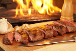 grilled sliced flank steak with flames