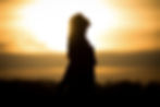 Youth woman soul at orange sun meditation awaiting future times. Silhouette in front of su