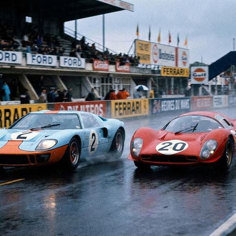 Ford GT40 racing Ferrari head to head at Le Mans in wet, rainy conditions