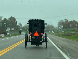 Horse-drawn Amish buggy on a rural highway in Owenton, Kentucky