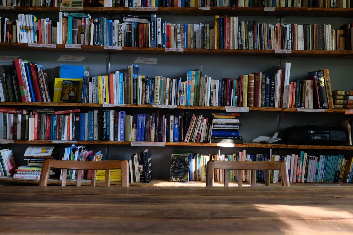 Wooden library shelves filled with books.