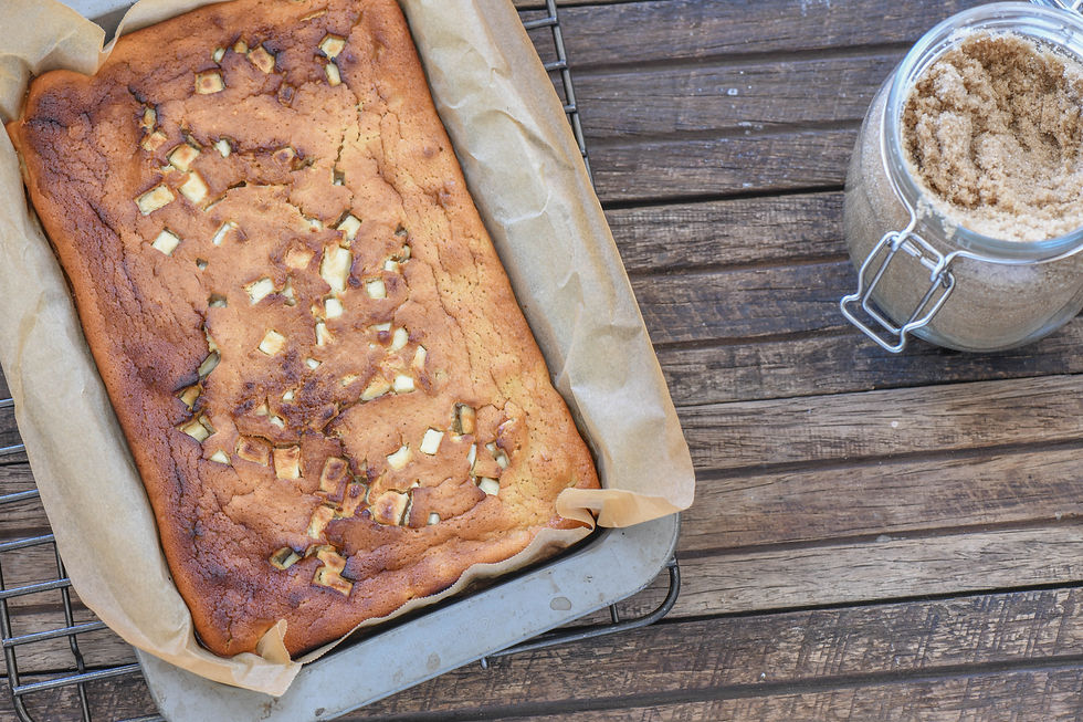 A tray of brown sugar blondies beside a jar of brown sugar