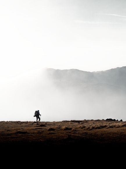 A Lone Hiker Emerges From The Cloud Surrounding Nethermost Pike. The Lake District, UK