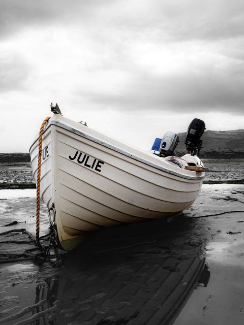 During low tide at Robin Hood's Bay, many boats are left displaced across the shoreline, patiently waiting for the tide to return them to the rhythmic waters.