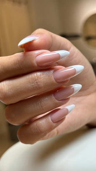 Almond-shaped French tip nails from a nail class.