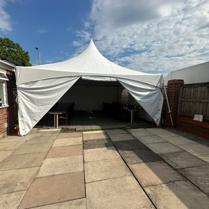 6x6m marquee pagodas in the garden, including wooden tables, chairs, festoon lights , plastic flooring and a bouncy castle