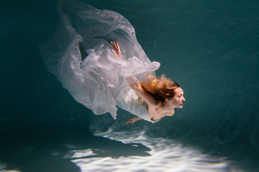 young woman posing submerged underwater
