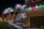 Holiday lights on a modern stone-front home