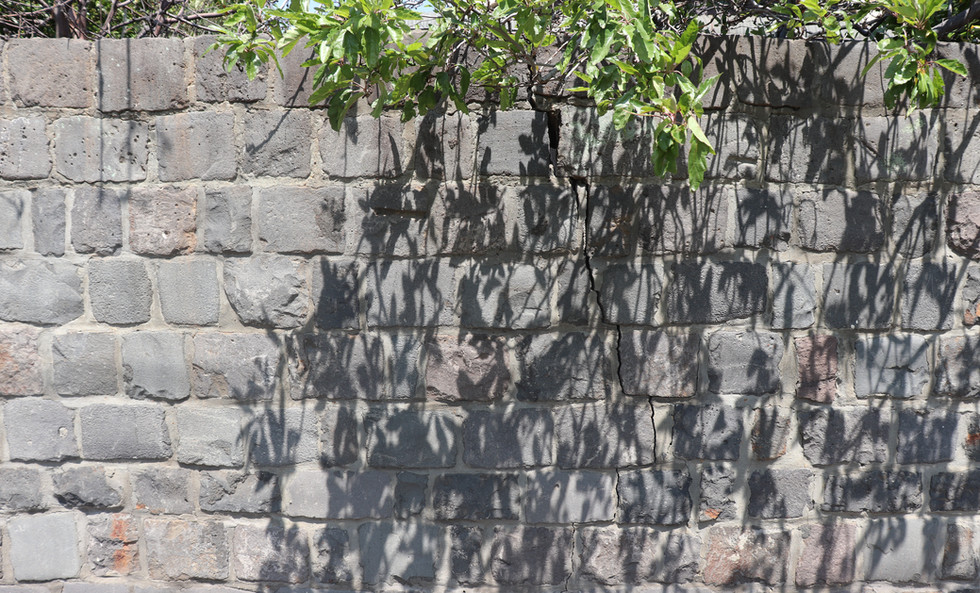 Cracked bluestone wall.