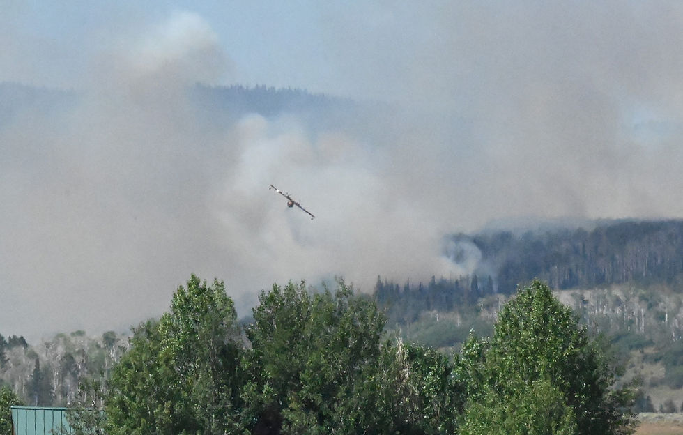 An air-scooper aircraft drops water over the Crosho Fire on Wednesday Afternoon.