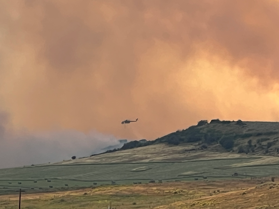 A helicopter outfitted with a "snorkel" brings water from a nearby lake as it works to slow the Crosho Fire in South Routt County on Aug. 13. (Kari Dequine Harden/For The Yampa Valley Bugle)