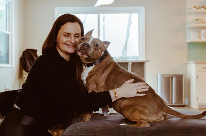 Woman face to face with her adopted dog. 