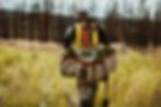Rear view of a forest ranger with bags full of pine seedlings for reforestation. Man worki