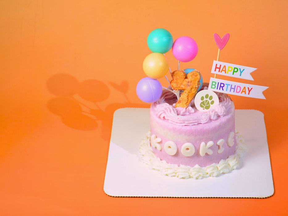 Signature dog birthday cake from Kookies Cookies Calgary dog bakery with custom name Kookie, birthday number and cake topper