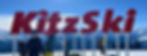 Kitzski logo op de skipiste met op de achtergrond besneeuwde bergtoppen
