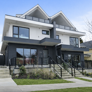 Northeast angled view of a side by side duplex with contemporary gable roof forms, front stairs, and street facing patios in Kensington Cedar Cottage.