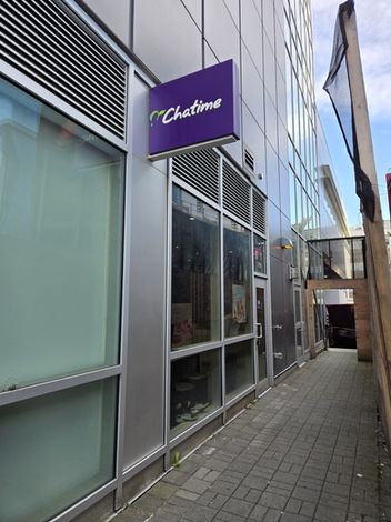 Exterior view of the Chatime storefront signage on the building façade along a covered sidewalk.