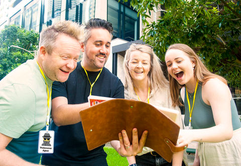Colleagues laughing during a corporate team-building event.