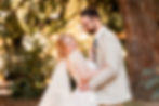 Bride and groom smiling at each other before a kiss during bridal portraits at Dunedin Botanic Garden, natural wedding photography by Dunedin wedding photographer