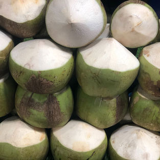 Young green coconuts piled on top of each other