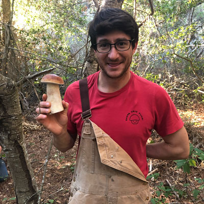 Man holding a small porcini in hand