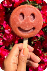 Hand holding red popsicle