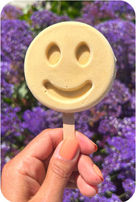 Hand holding yellow popsicle