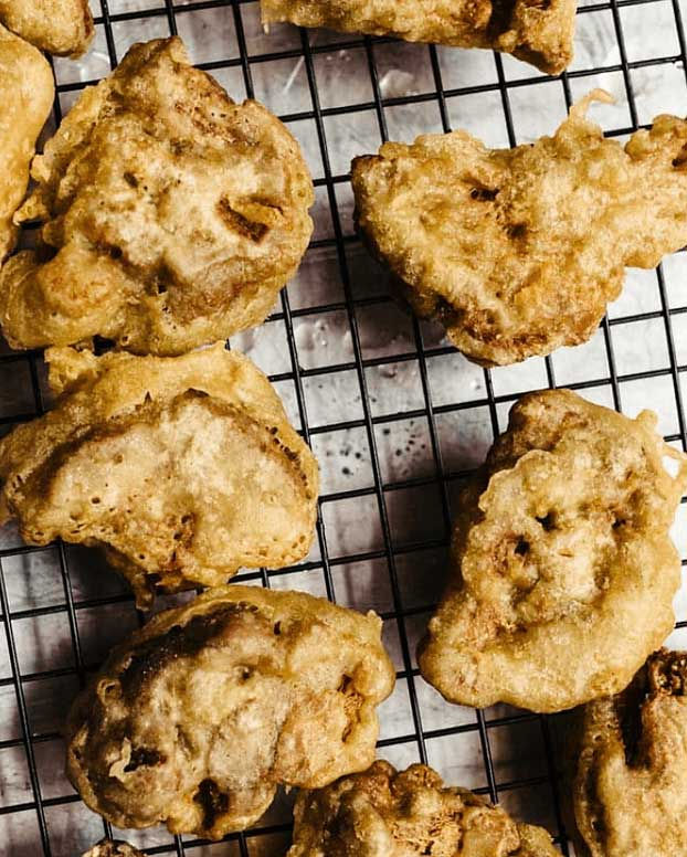 Soft boiled egg with black trumpets and black lentils on dish