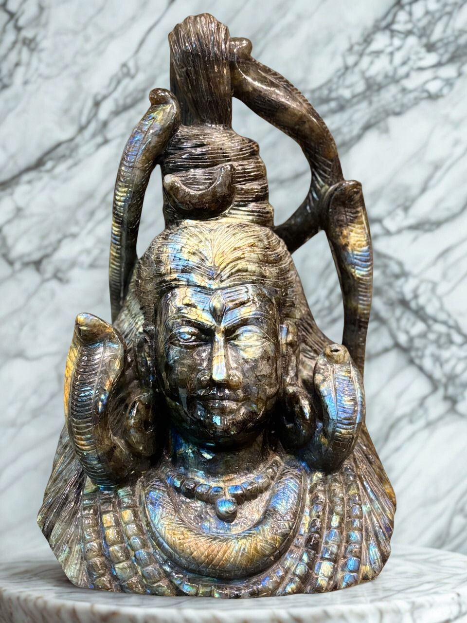 Hand-carved bust of Lord Shiva made from iridescent labradorite stone.