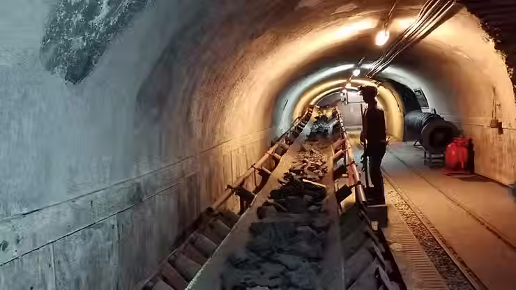 Workers inspecting a metro tunnel lined with fire-resistant concrete designed to withstand high temperatures and prevent explosive spalling.