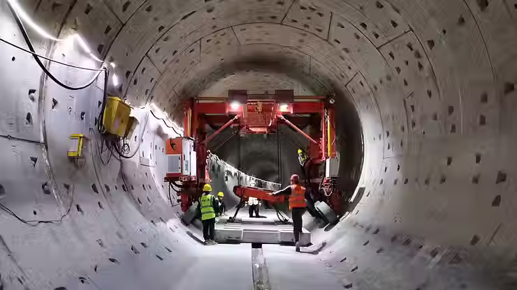Workers installing PVA fiber-reinforced UHPC tunnel segments to improve structural integrity under extreme loads.