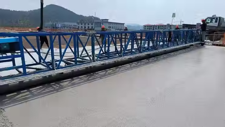 Smooth concrete surface after pouring on a bridge deck, demonstrating the improved workability and crack resistance achieved by incorporating alkali-resistant fibers into the mix for enhanced long-term performance and reduced maintenance needs.