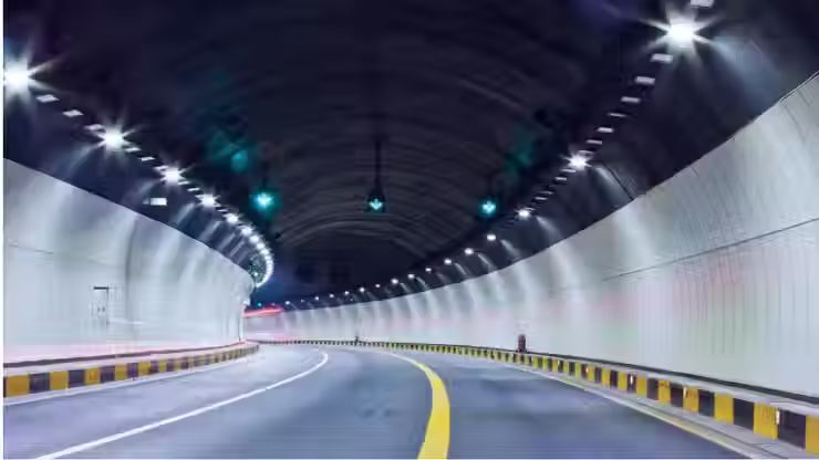 Modern tunnel roadway paved with polyester fiber-reinforced asphalt for improved durability, crack resistance, and long-term performance.