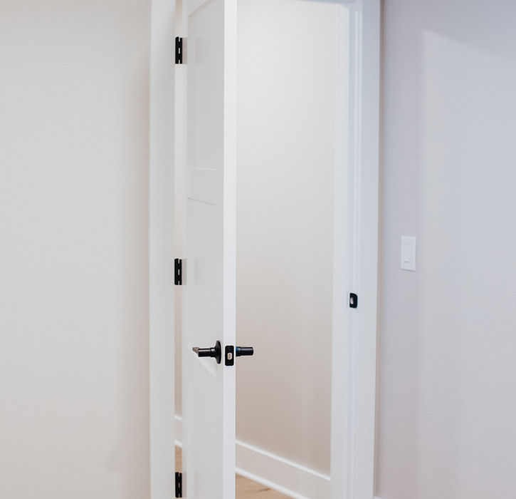 A white door opened, from within the room it opens unto.