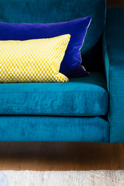Rich teal blue velvet armchairs. Interior design Symmetry Styling. Contrasting yellow and vivid purple velvet cushions.