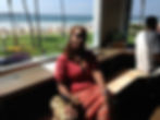 Meet Ronda, your consultant, seated by a window with a beach view.