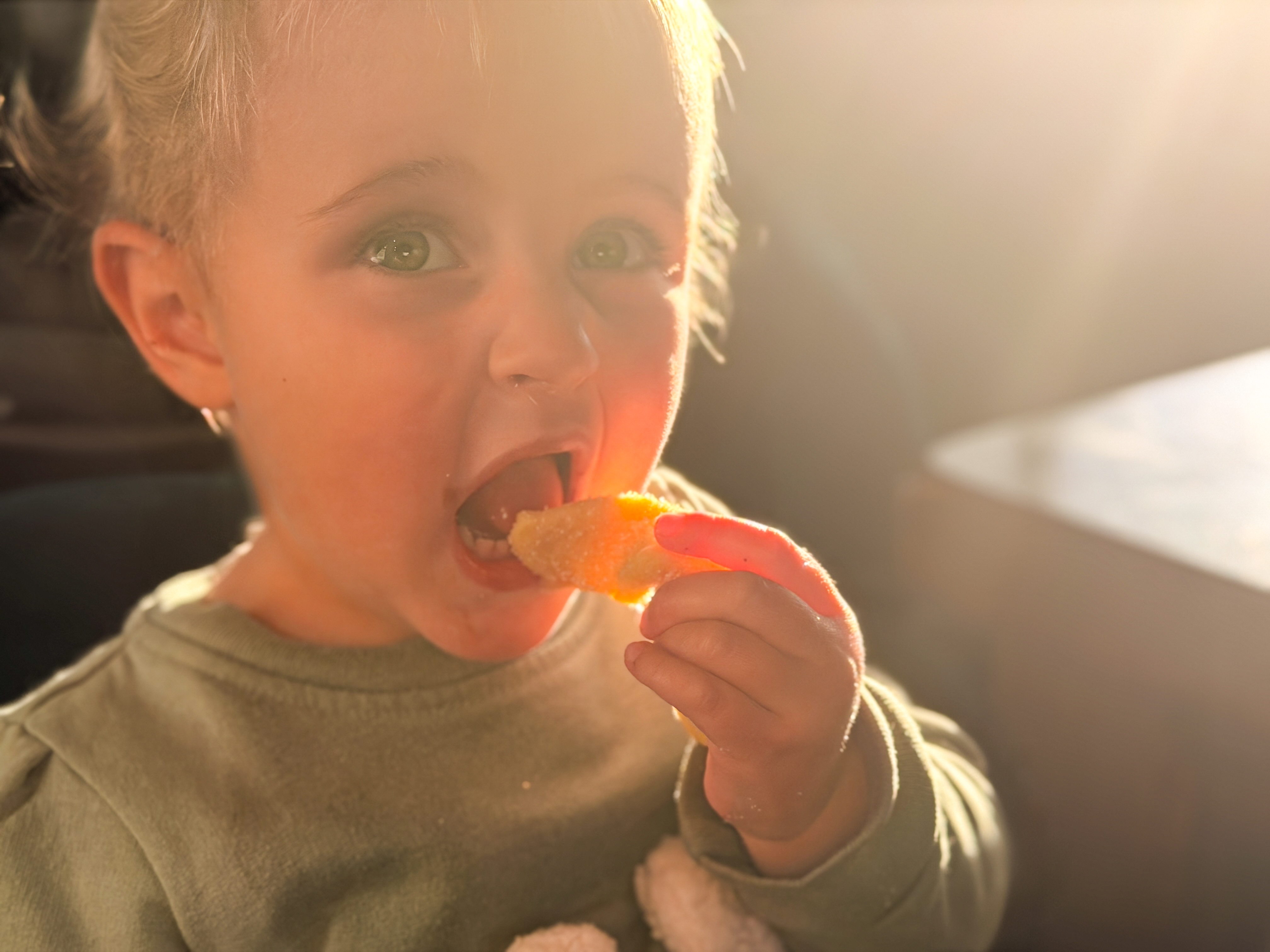 A young child enjoying a fresh pastry