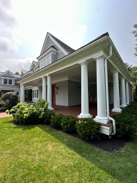Luxury home with white pillars and grey painted exterior