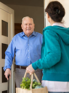 home-caregiver-woman-helping-senior-man-royalty-free-image-1584722002.jpg