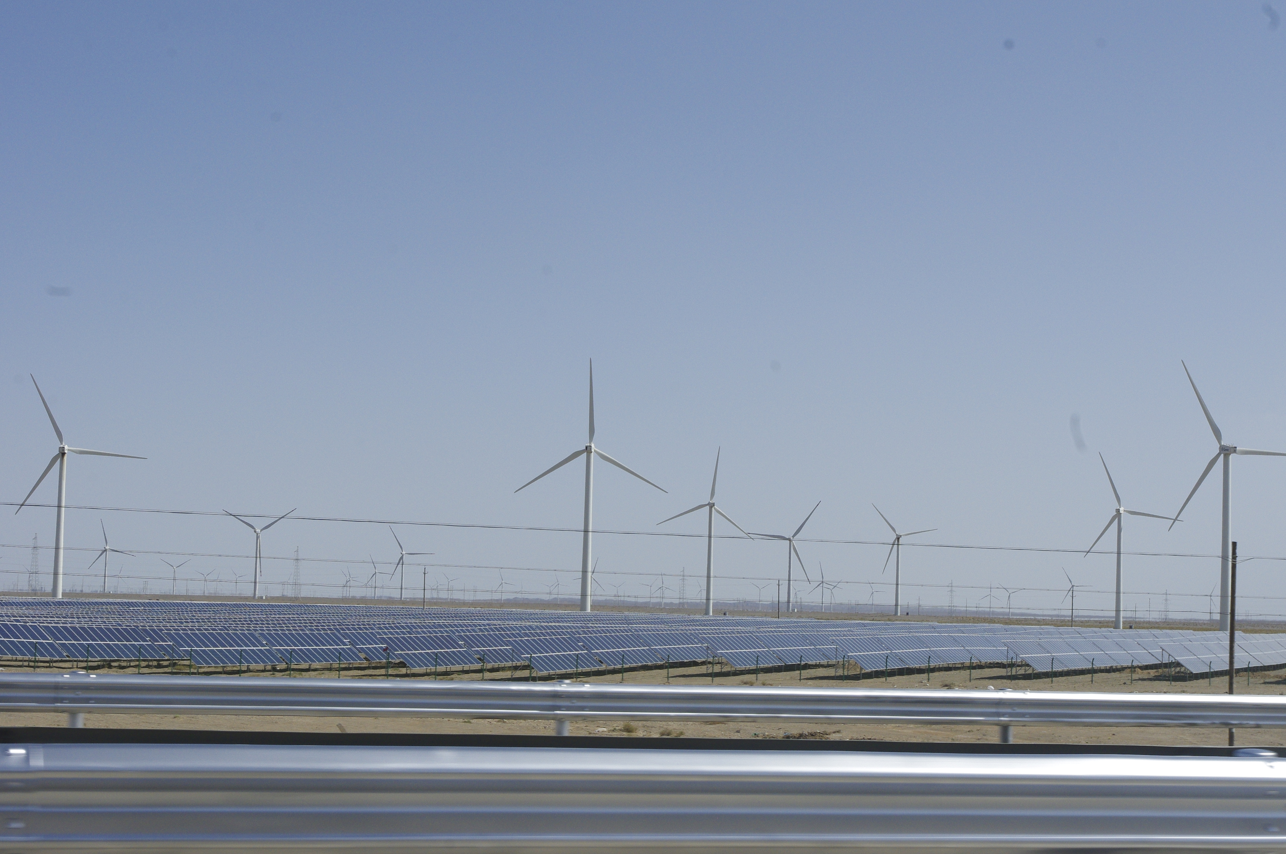 Solar panels and wind turbines at a renewable-energy installation in Xinjiang, China, archival photo