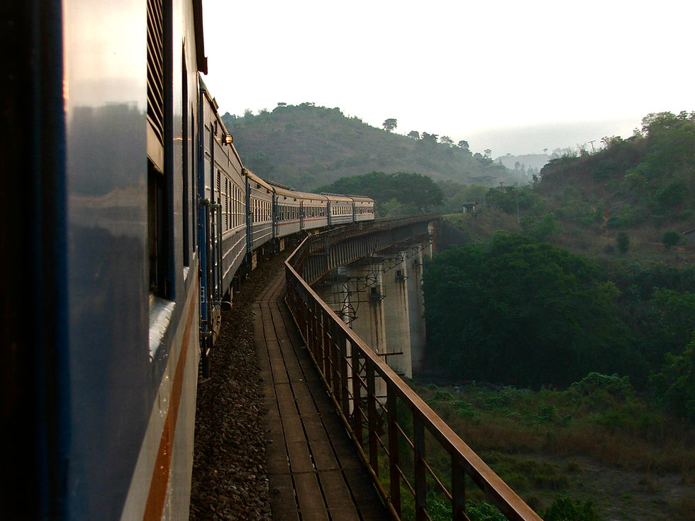Historic TAZARA passenger train on railway tracks.