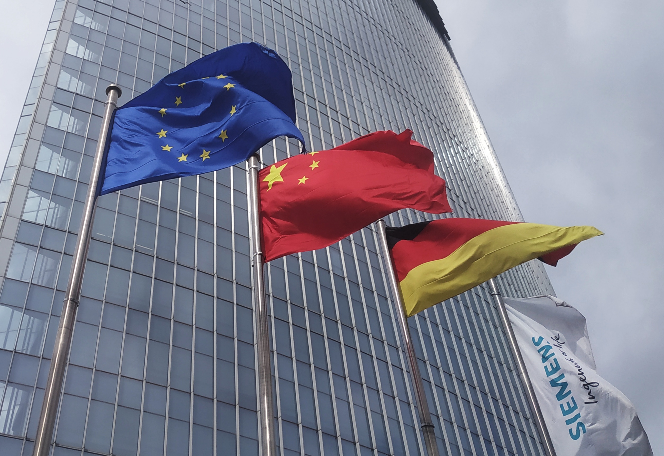 Archive 2019 photograph of European Union, Chinese, and German flags outside Siemens Tower in Beijing, not the October 2026 talks